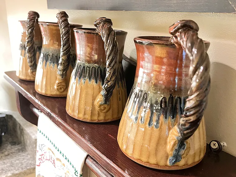 Coffee mugs on display made by a local potter.