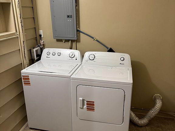 Dedicated laundry area with a full-size washer and dryer set, providing convenient in-home laundry access.