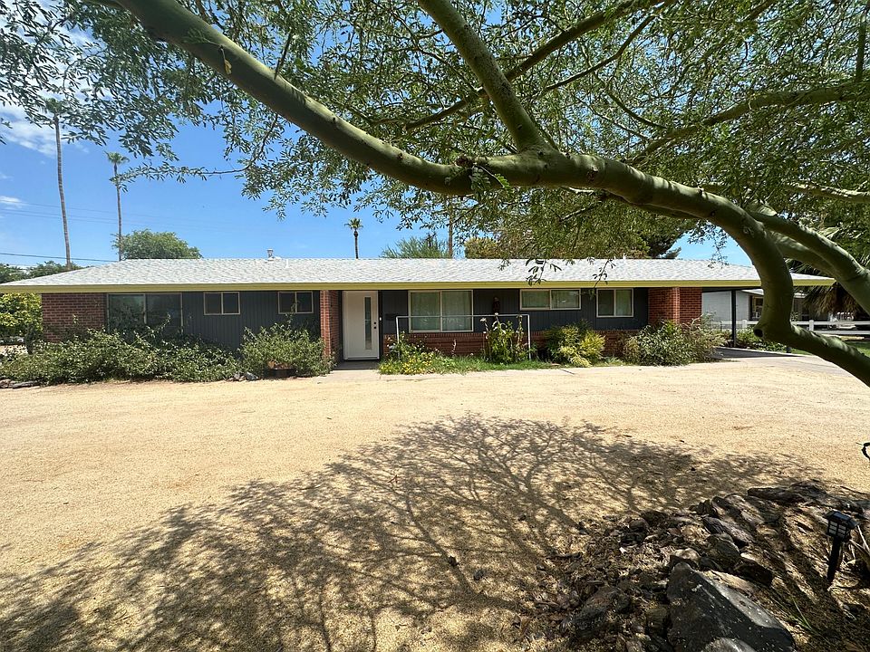 The home has a drive-through corner lot, with a number of shady parking spots.