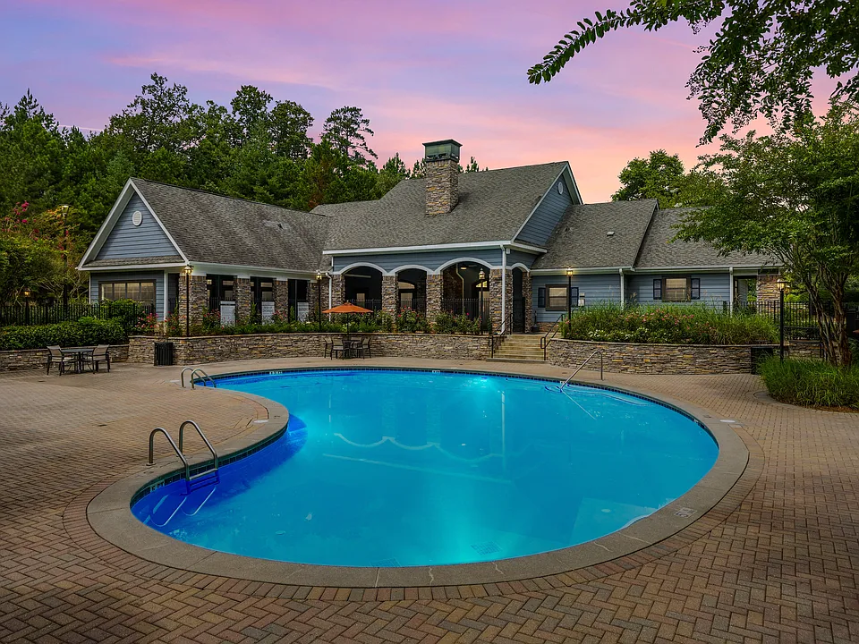 Swimming pool and clubhouse at sunset