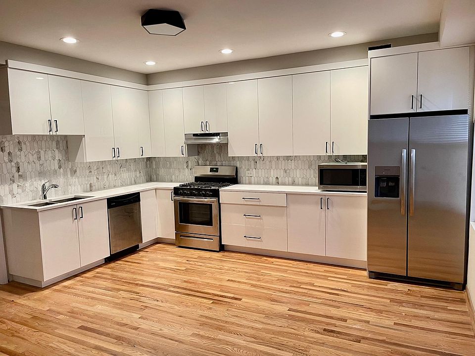 Brand New Kitchen with Quartz Countertops, state of the art white cabinetry, porcelain tile backsplash and stainless steel appliances!