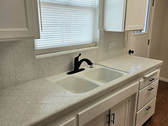 Double sink with trash compactor.