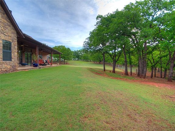 Large Backyard is Fenced but 5 Acres goes out Beyond and is also Fenced at Back of Property.