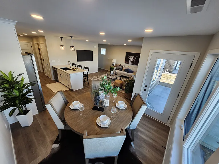 Dining space looking toward living room. (Pictures are of another unit with similar finishes and features.)