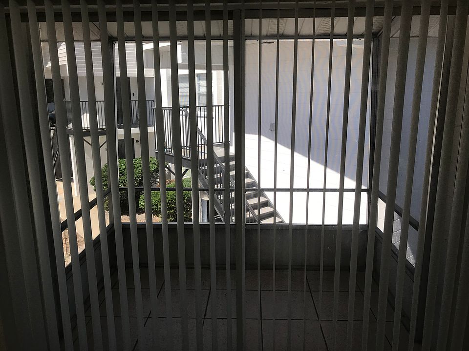 Sliding glass door entry to screened outdoor balcony.
