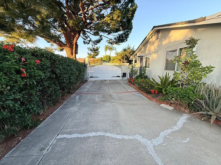 Driveway with recently painted motorized remote-controlled gate.