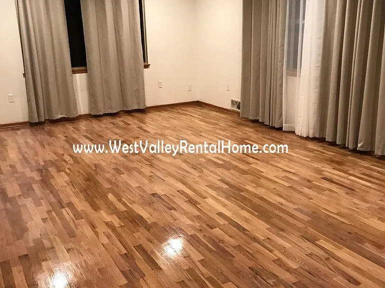 Giant, welcoming living room with brand new, beautiful, energy efficient window treatments and newly finished hardwood floors!