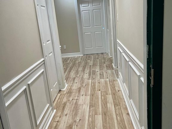 Interior hallway from front door with beautiful wooden wainscoting