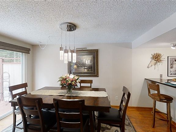 Formal dining with a view of the backyard/deck.  This space is perfect for entertaining and is easy to serve dishes through the breakfast bar area in the kitchen.
