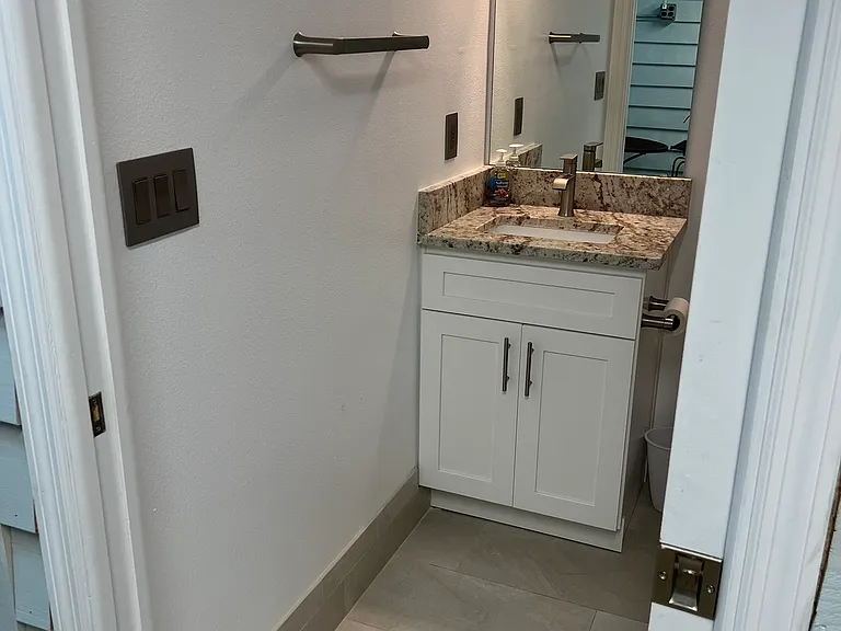 The bathroom area is directly adjacent to the interior patio area. No need to disturb a person sleeping in the bedroom.