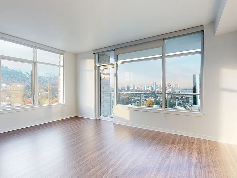 Apartment Living Room with Wood-Style Flooring and Balcony.