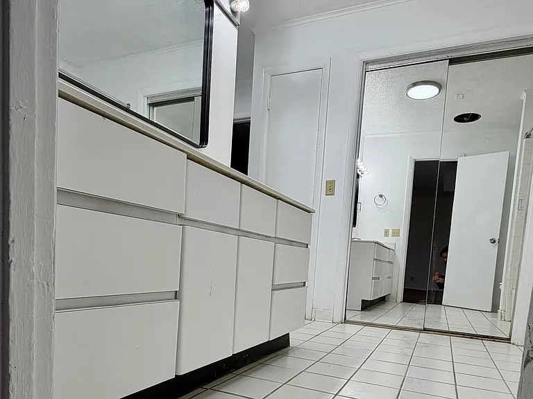 Bathroom 1. lots of storage. mirrored closet doors.