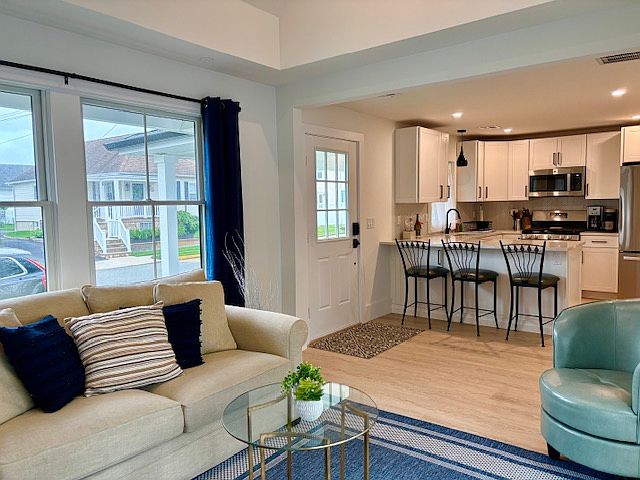 Open plan living/dining area with counter seating. Sofa is a full size sleeper.