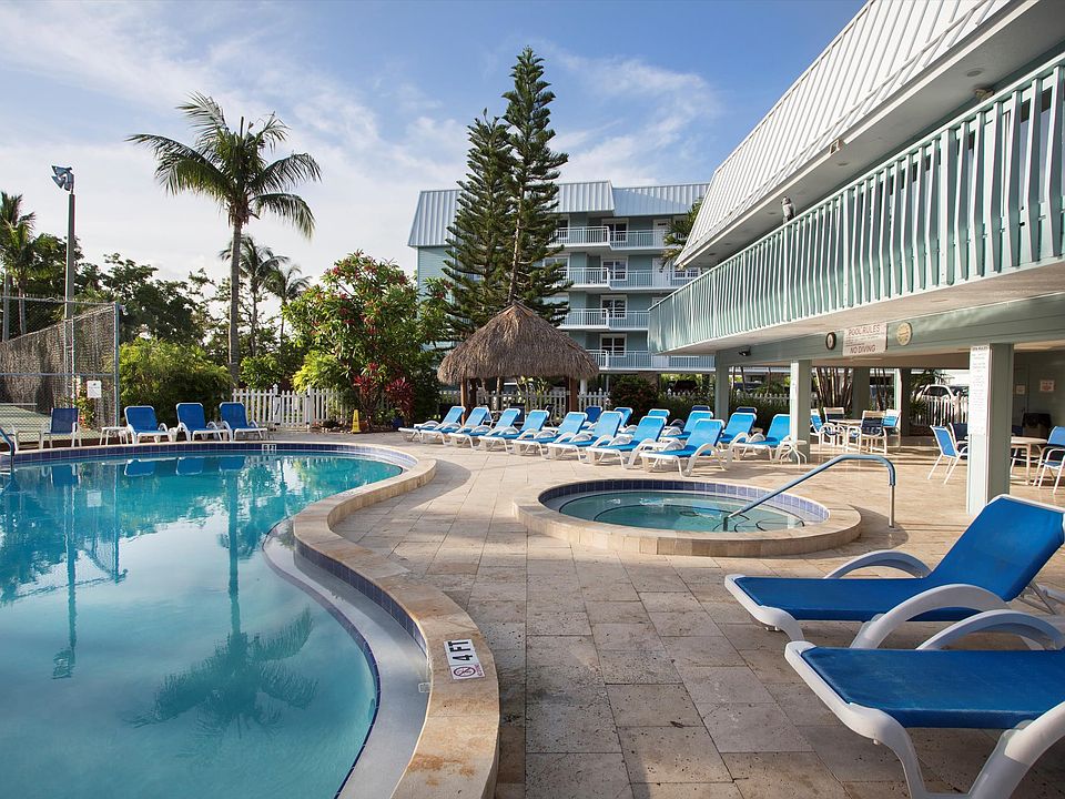 Plenty of seating offering for sunbathing or covered options. Hot tub and large pool.