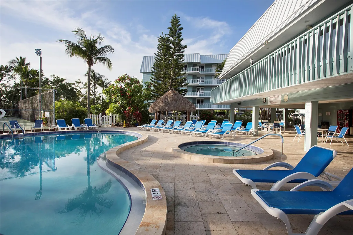 Plenty of seating offering for sunbathing or covered options. Hot tub and large pool. - 1901 S Roosevelt Blvd #102