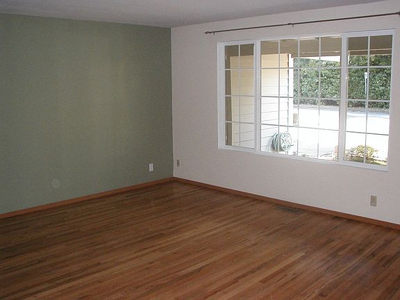 The living room showcases the red oak hardwoods that are throughout the house.