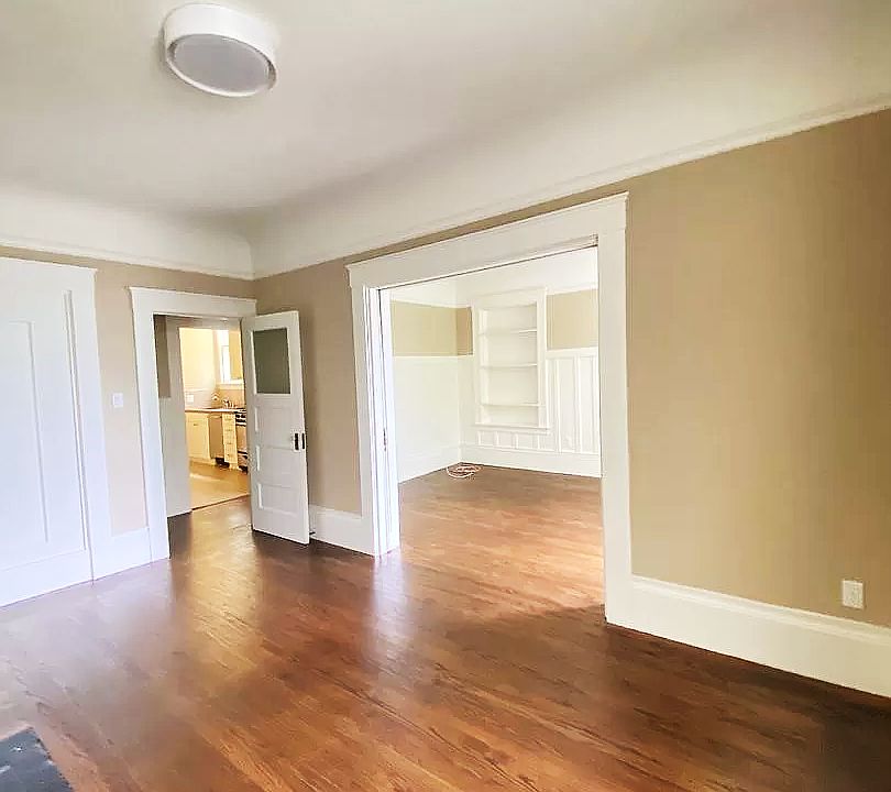 Living Room: In addition to newly finished hardwood floors, the Living Room has high vaulted ceilings and Bay Windows. The rooms enjoy a lot of natural light. When pocket doors are open, it can be combined with the Bedroom to make for a large Master Room.