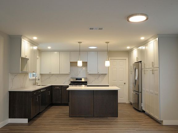 Remodeled kitchen with appliances, quartz countertop, custom KraftMaid cabinets. Added skylight over stove.