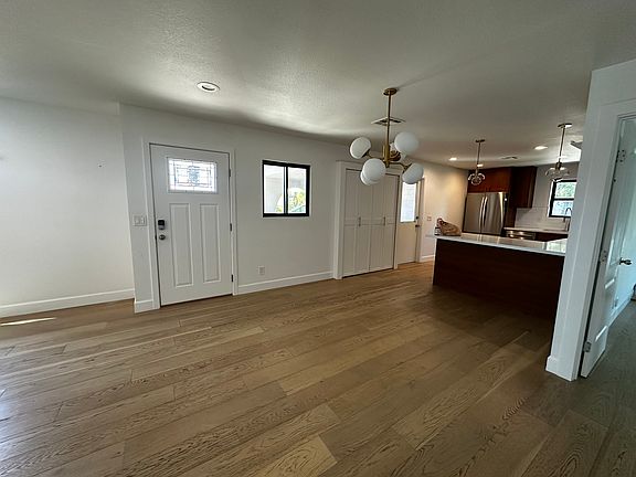 Open floor plan connects kitchen, dining and living room. Plenty of room for a 60-inch round table and barstools at the kitchen island.