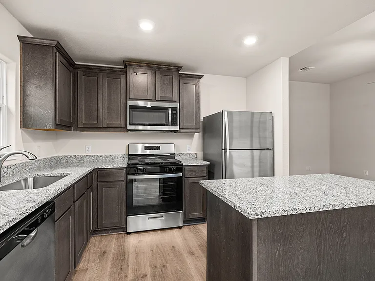 The kitchen has sprawling granite countertops.