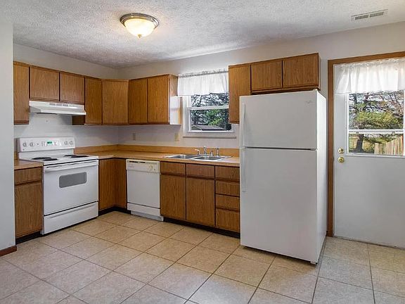 clean kitchen with natural light and room for dining