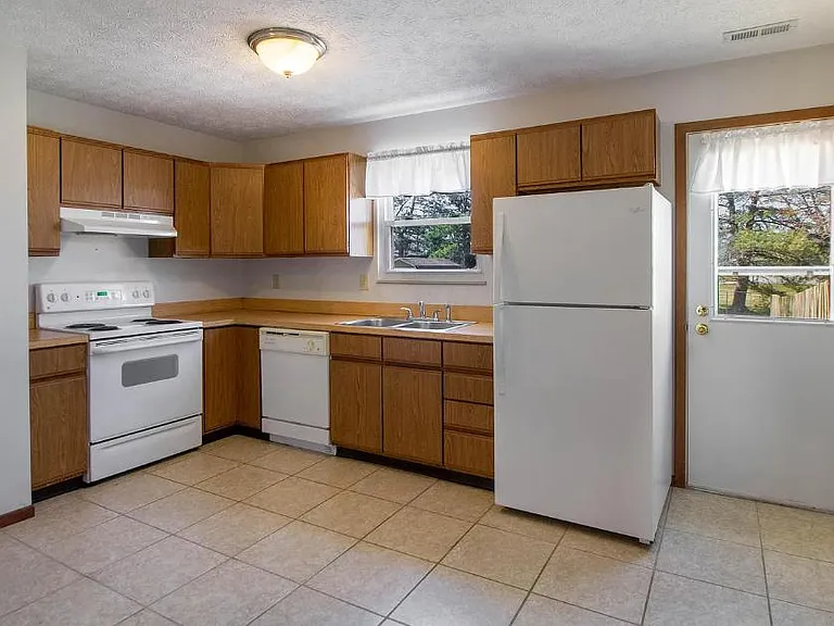 clean kitchen with natural light and room for dining