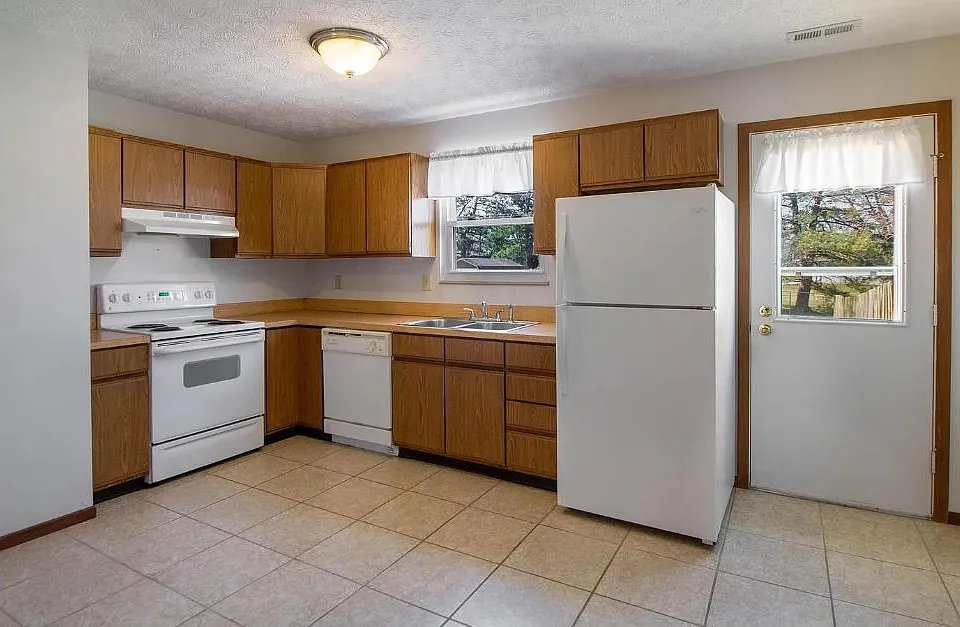 clean kitchen with natural light and room for dining