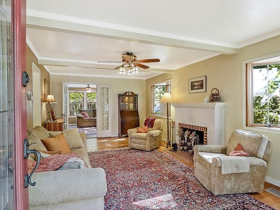Living room with an adorable fireplace and wood flooring.