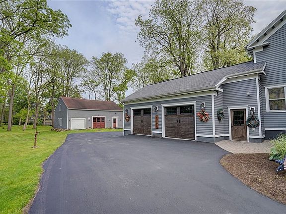 Newly sealed driveway leads to an immaculate and o