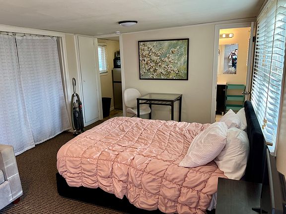 Full size bed with storage drawers on both sides. Dining table with two chairs. Privacy blinds on all windows.