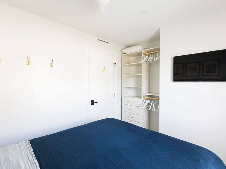 Open concept closet with TV in the Master Bedroom.