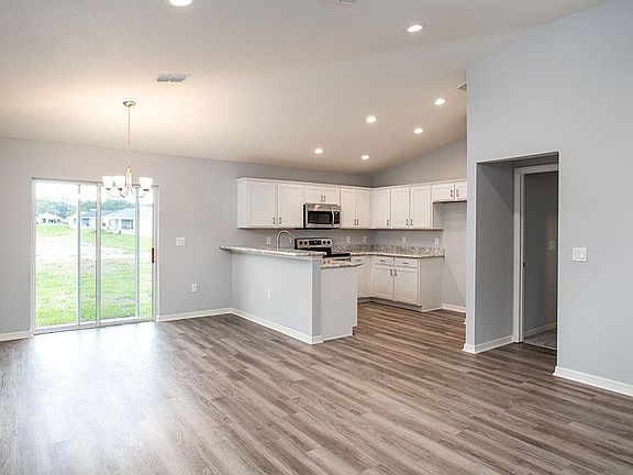 Enjoy a sunny, open living area with volume ceilings - Camellia home plan by Highland Homes