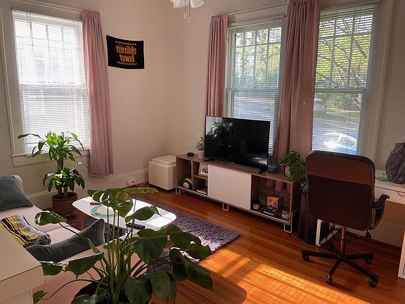 Living Room with tall ceilings and ceiling fan. Hardwood floors