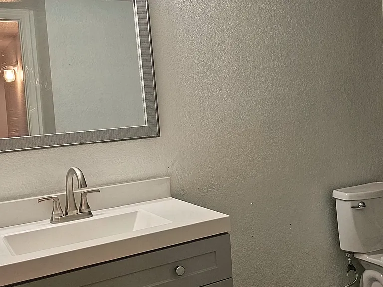 Lower-level bathroom featuring an updated vanity, modern fixtures, and a clean, functional design.