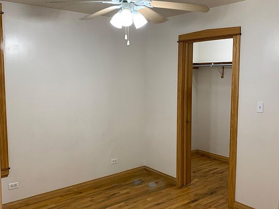 Bedroom 1 features ceiling fan and walk in closet