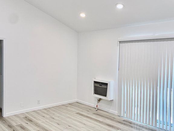 Living Room with vaulted ceilings and balcony.