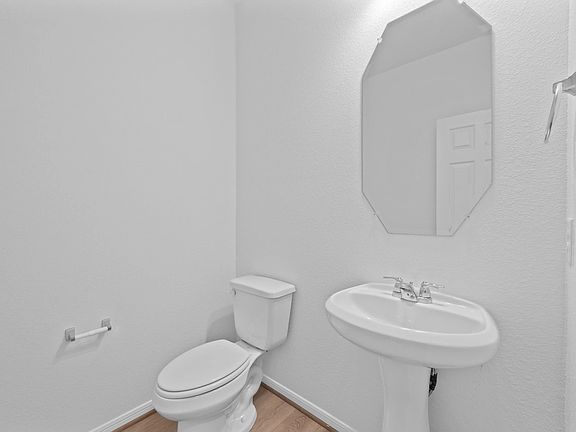 This charming home features a beautifully appointed half bath adjacent to the family room, perfect f