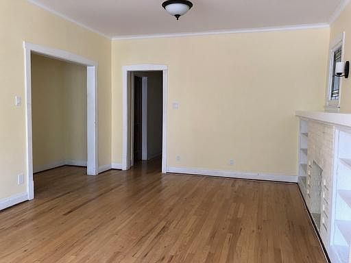 This image shows the living room looking toward the entry foyer - a great place for a coat rack. Also shown is the hallway to the rest of the apartment beyond