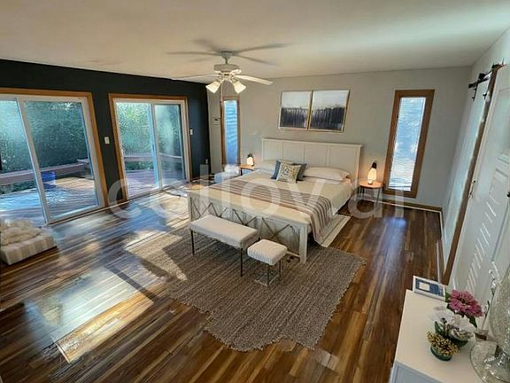Large 1st floor master bedroom with two sliding class doors leading to the wrap around deck. *furniture not included*