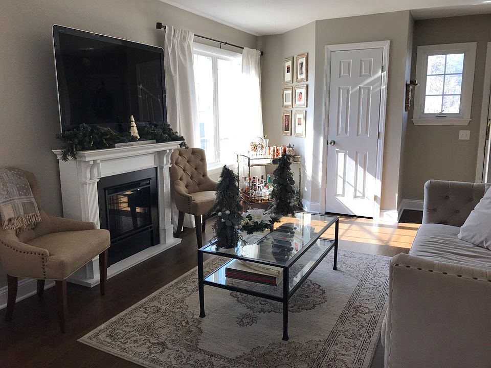 Living room and coat closet; electric fireplace.