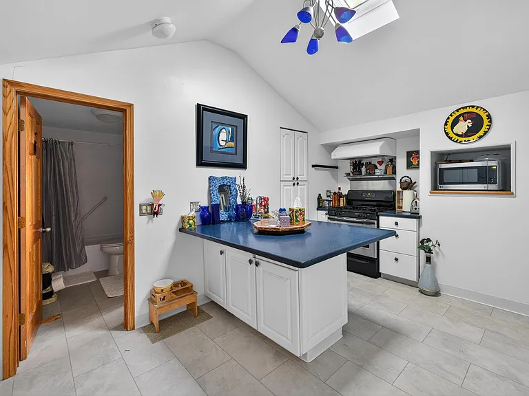 4 Burner gas stove and hood with heat lamps and exhaust fan. Microwave.
