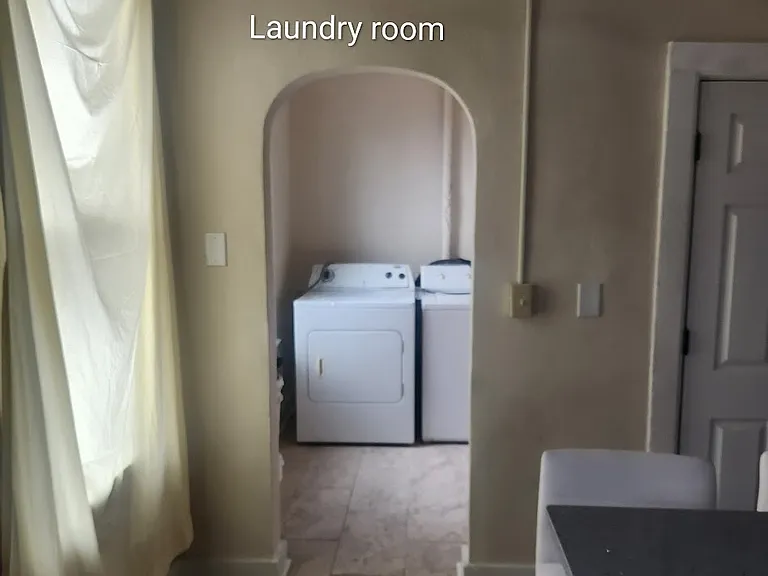 In kitchen looking in laundry room