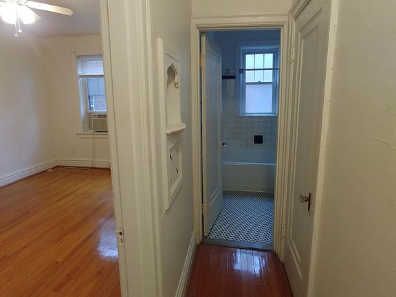 Hallway looking into bathroom and bedroom 1.
