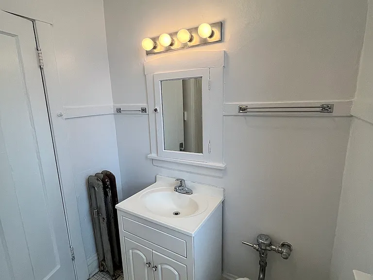 Bathroom with vanity, new faucet, commercial grade plumbing.