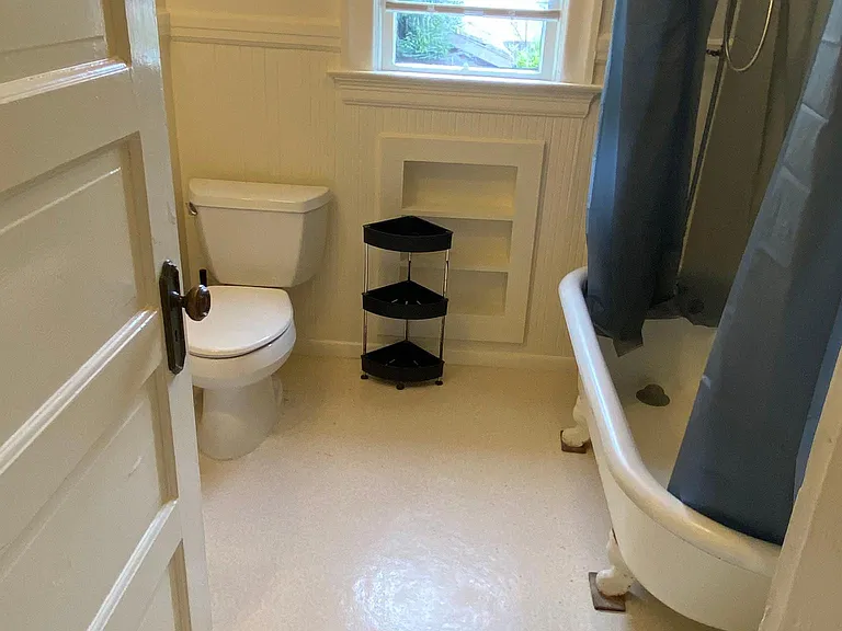 Bathroom with vintage clawfoot tub --accessed through back bedroom