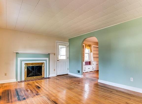 LR: Wood-burning fireplace & access to side porch