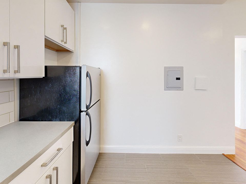 Kitchen with cabinets and refrigerator