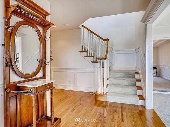 Enter to a lovely staircase and hardwood floors