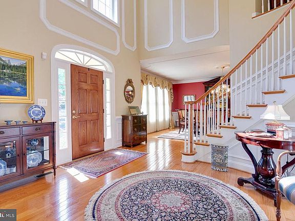 Foyer with crown molding and wainscotting