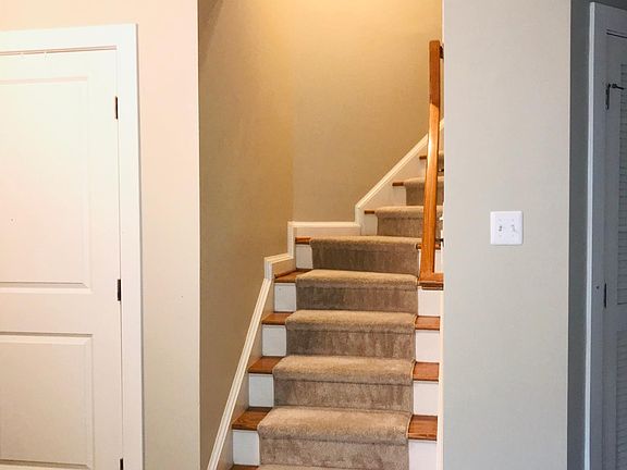 Stairs to the main level. Large, entry-level closet for storage, tiled floor and garage access.